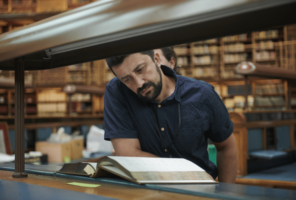 An ITP participant reading a book in the British Museum archives.