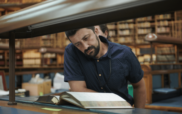 An ITP participant reading a book in the British Museum archives.
