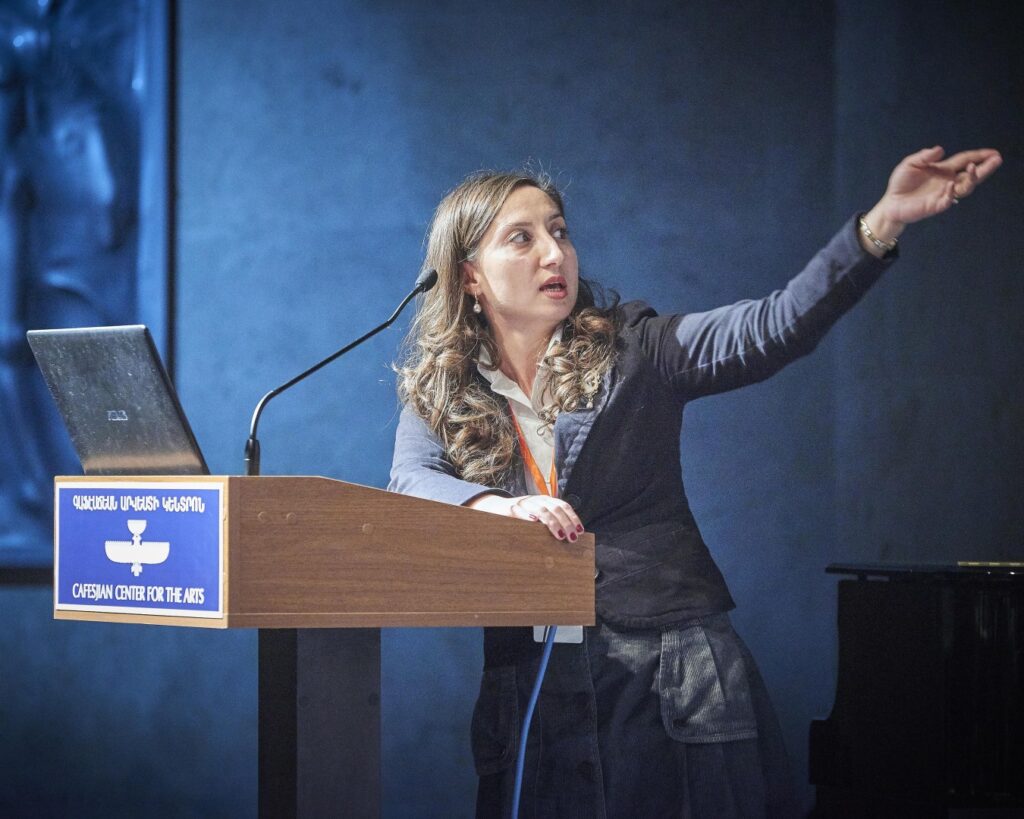 ITP fellow standing at a lectern giving a presentation