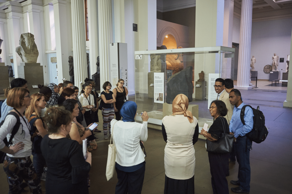 A tour group gather around the Rosetta Stone display at the British Museum