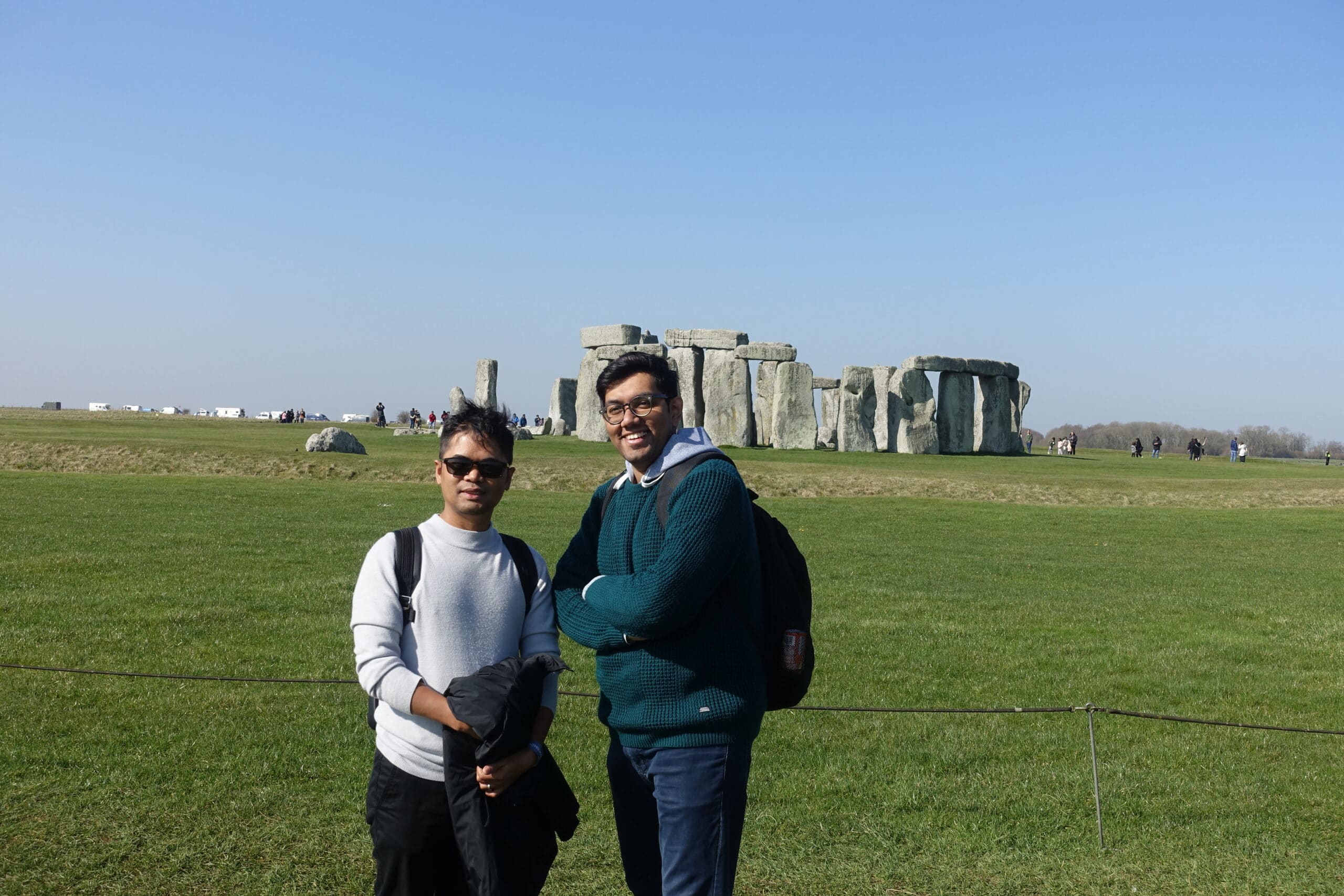 Two people take a photo in front of Stonehenge