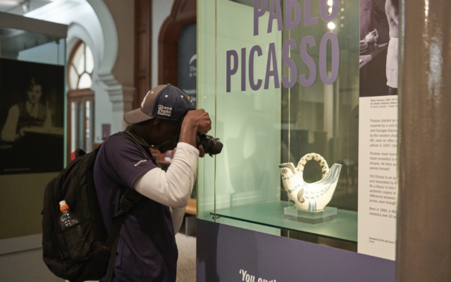 ITP fellow taking a photograph of a museum display