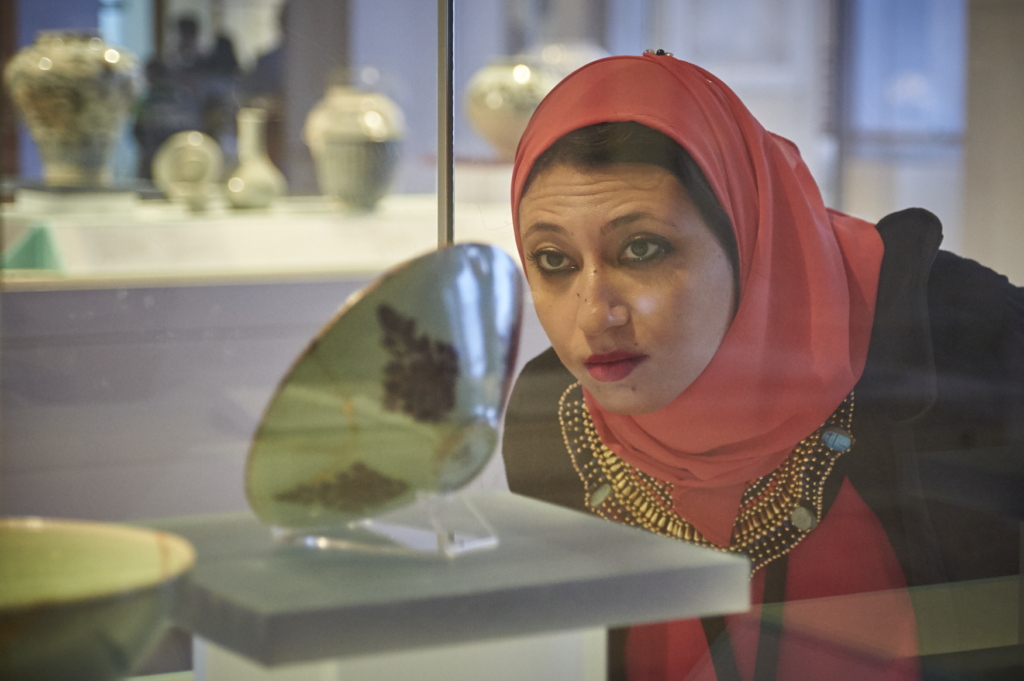 ITP fellow Shreen Amin looks closely at a museum display