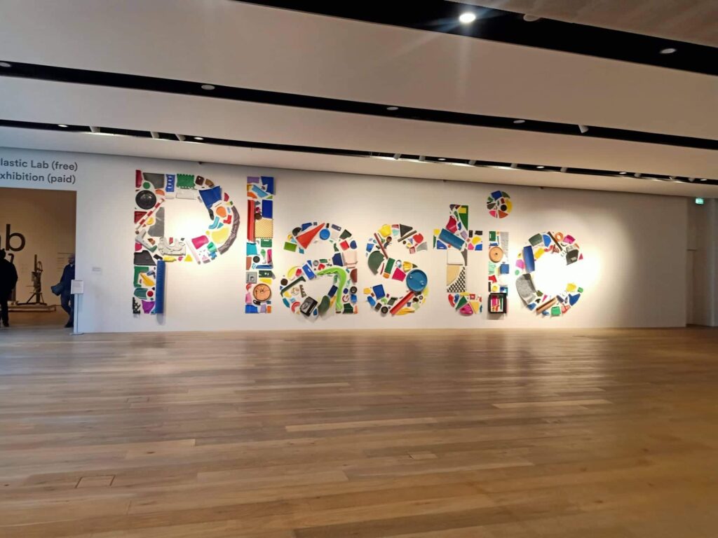 Exhibition sign that reads PLASTIC, made from pieces of colourful recycled plastic