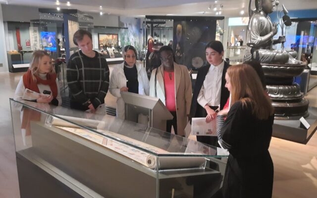 A group stand around an interactive museum display at National Museum of Scotland