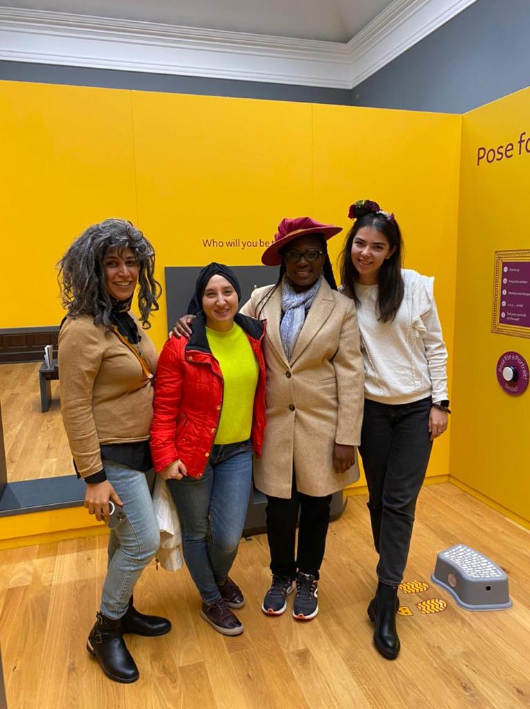 Group of four ITP fellows dress up in Aberdeen Art Gallery displays
