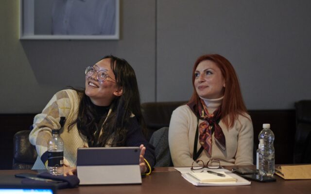 Kezia Permata and Tatevik Saroyan sitting next to each other during annual programme session