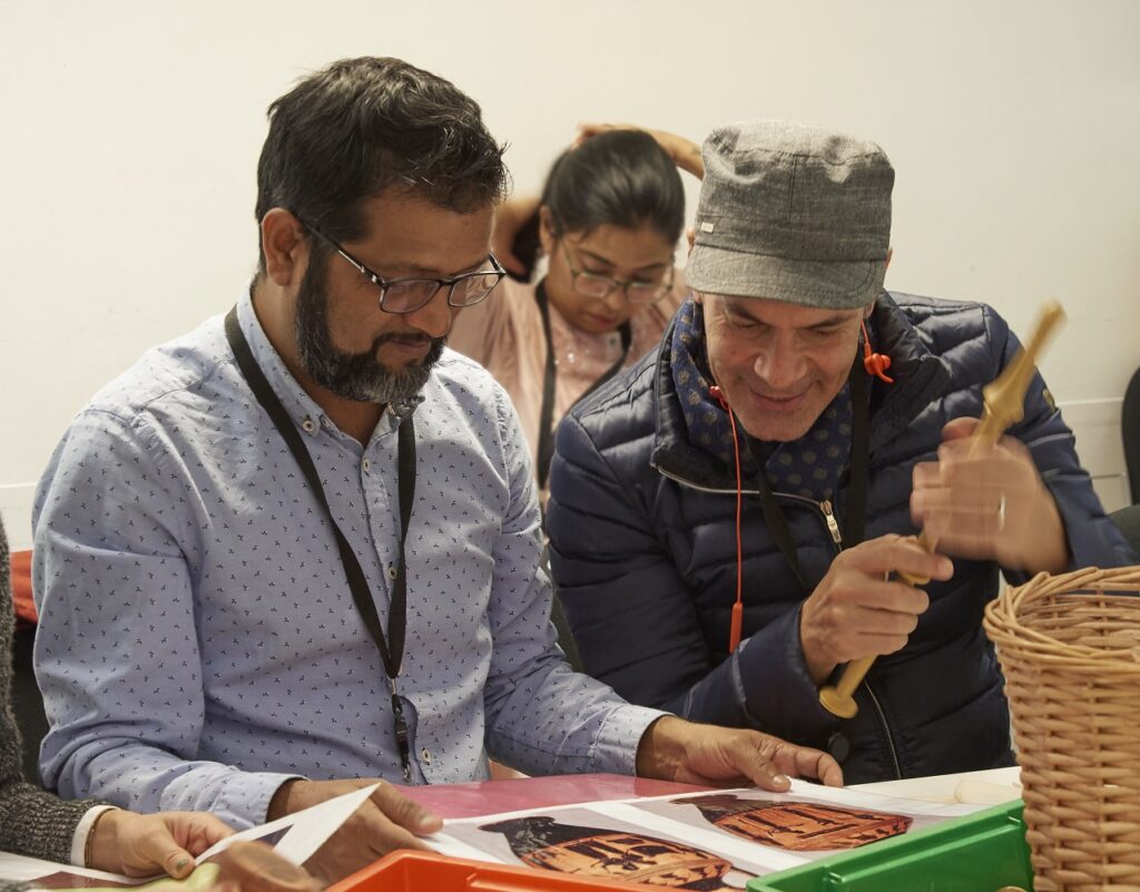 ITP Senior fellow Roshan Mishra and ITP fellow Lotfi Belhouchet look at activity sheets from the ITP session on museum learning