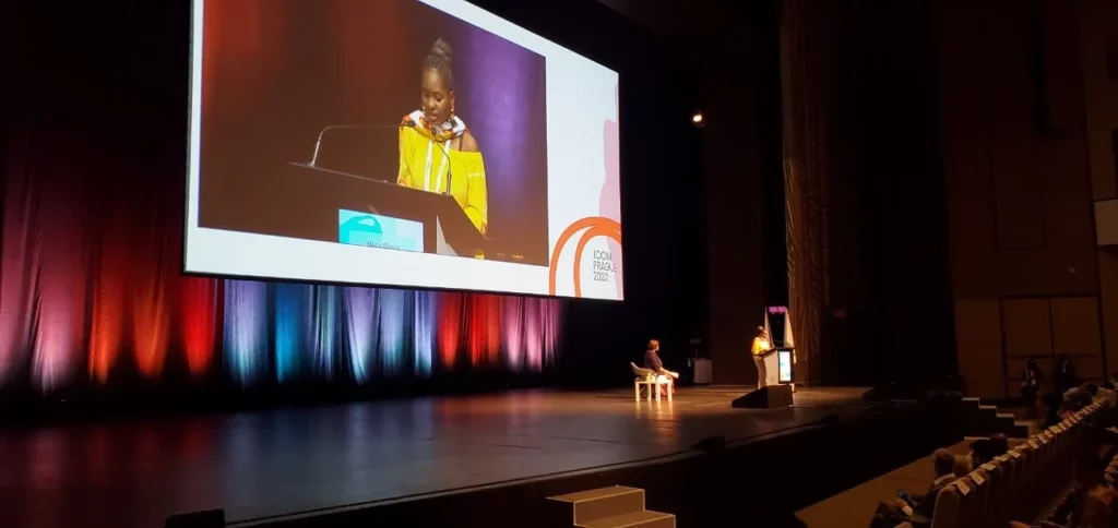 Hilda Flavia Nakabuye speaking on stage in her keynote speech about the climate crisis