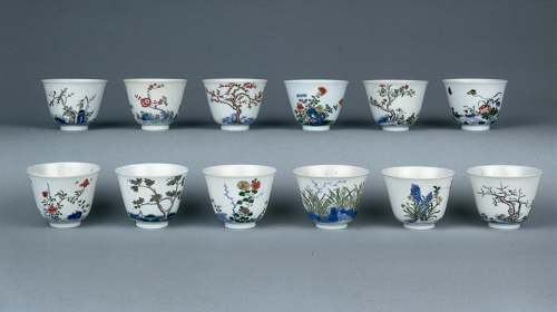 Set of twelve porcelain wine-cups There is a different seasonal tree, shrub or flower, to represent one of the twelve months, in 'famille verte' palette enamel and underglaze blue on the exterior of each cup.