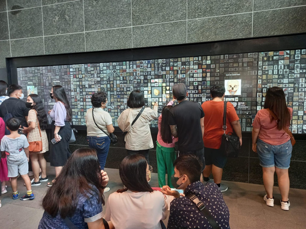 People looking at a digital gallery wall.