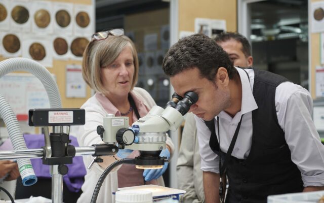 2023 ITP fellow Mamdouh Farouk looking in to a microscope.