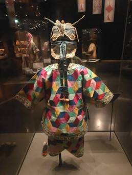 Photograph of a child's hat, jacket, trousers and shoes in the Baijiayi tradition.