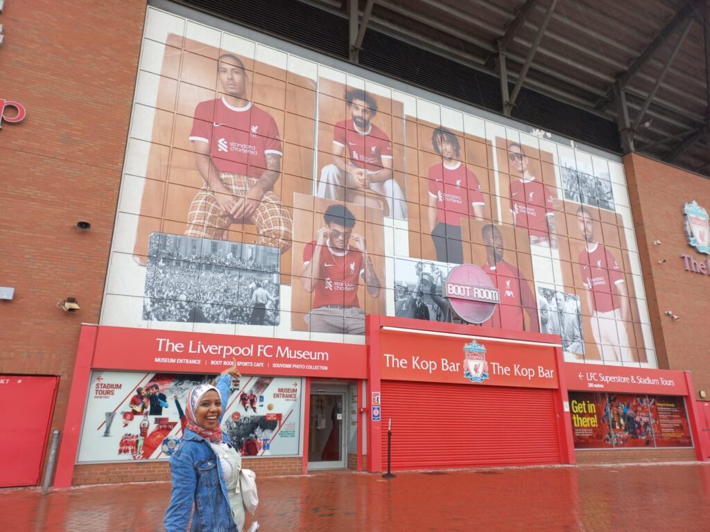 Dina standing outside Anfield, Liverpool Football Club's stadium 