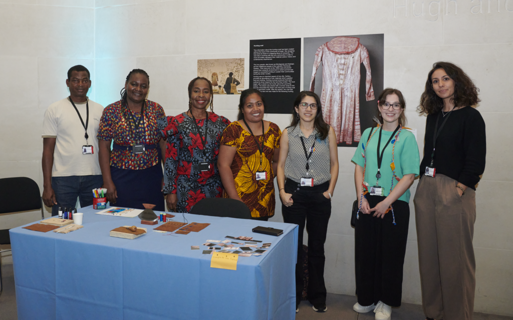 ITP fellows based in the Africa, Oceania and Americas department stand for a group photo with their Object in focus display. 