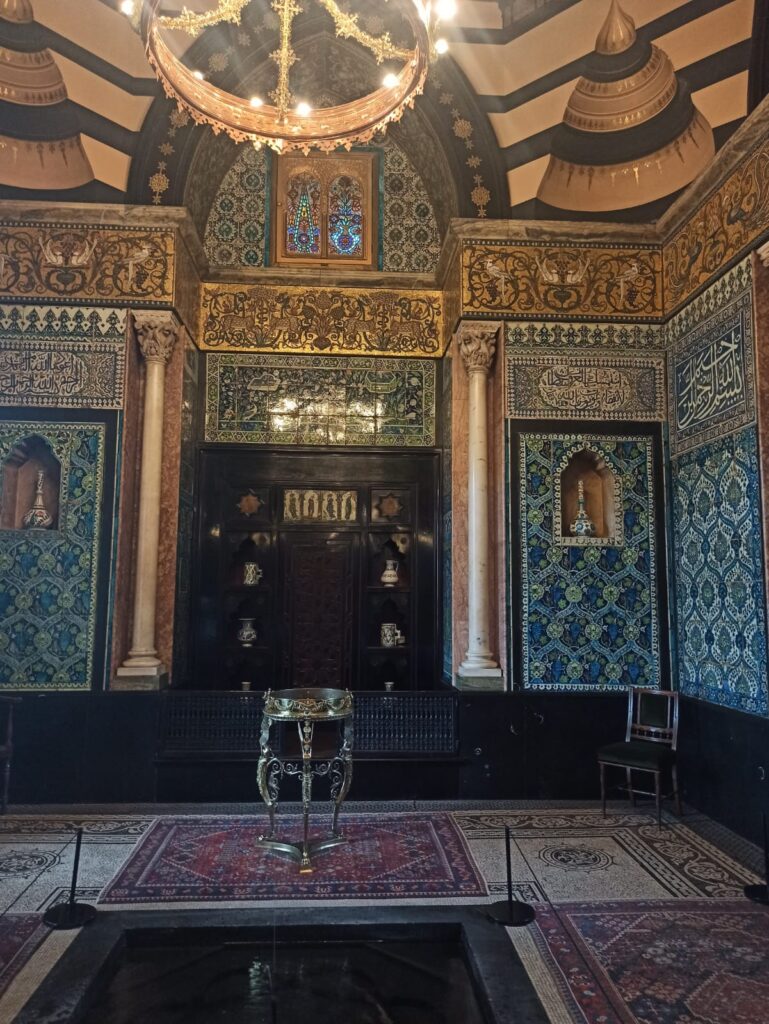 The fountain inside Leighton House Museum, surrounded by gold and blue interiors inspired by Middle Eastern motifs. 