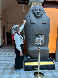 Nagwa standing next to an Egyptian statue