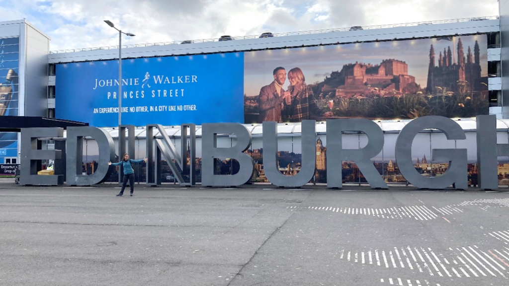 Rema standing in front of a huge 'Edinburgh' sign