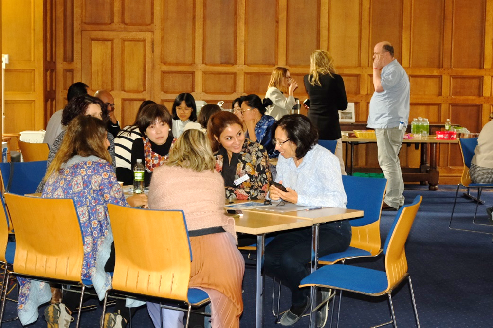 Rema sat at a table with others, engaging in the Workshop on Understanding Virtual Museum and Sustainability.