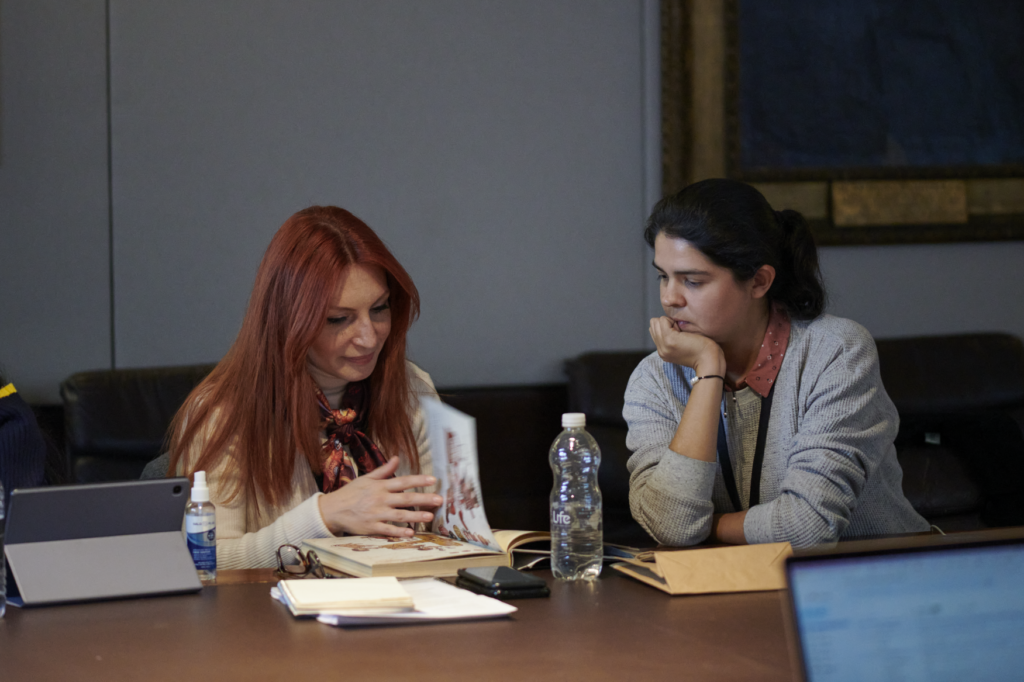 Yoanoa photographed next to another ITP fellow behind a desk.