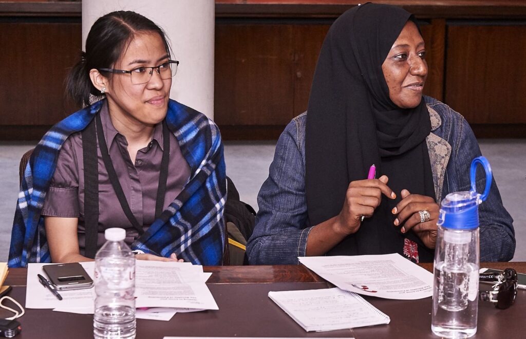 Yohana sat behind a desk with another ITP fellow.