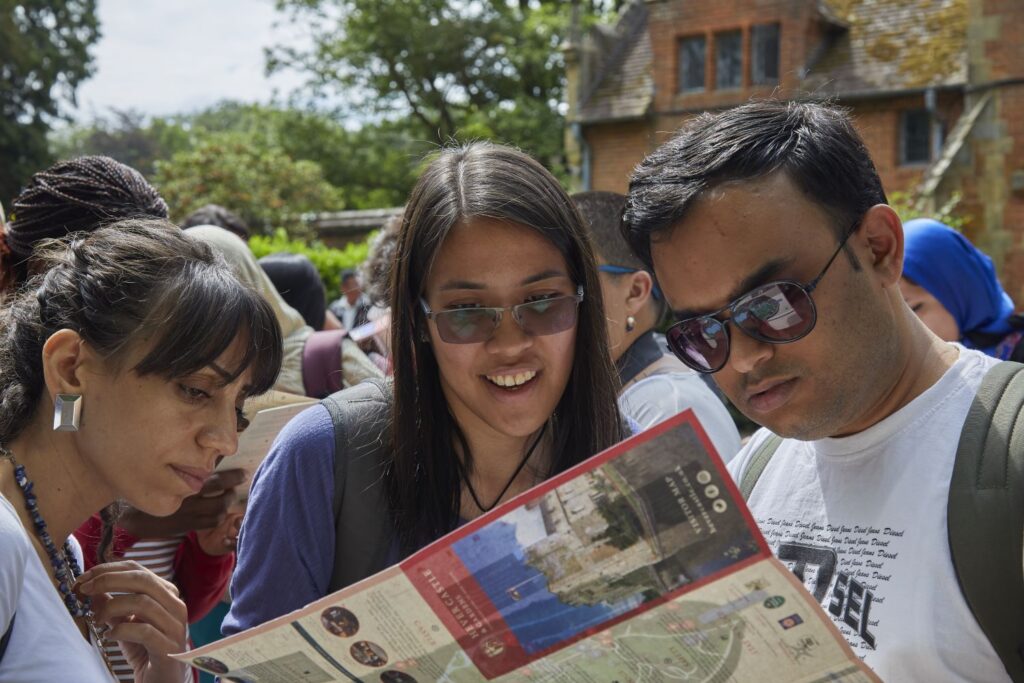 Yohana with two ITP fellows, looking at a map.