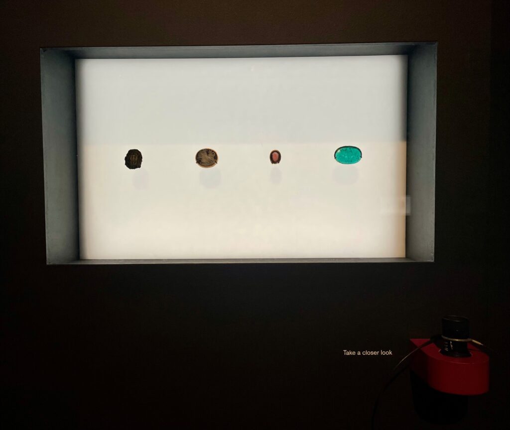 Photograph of a backlit case displaying 4 gems.