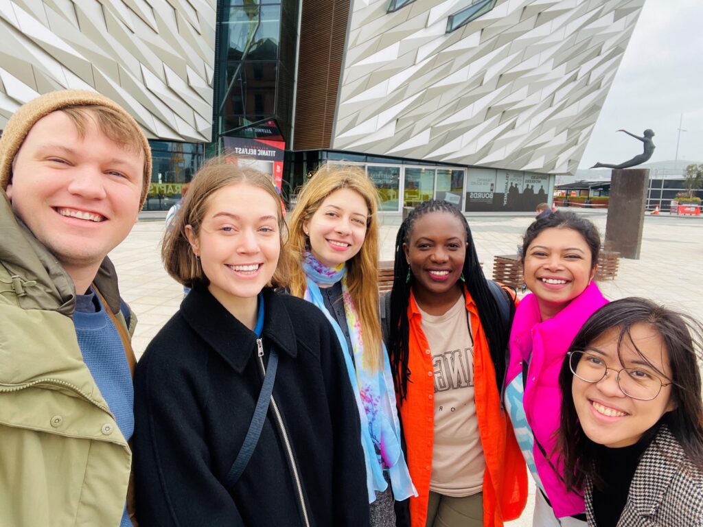 Photograph of 6 people, smiling.