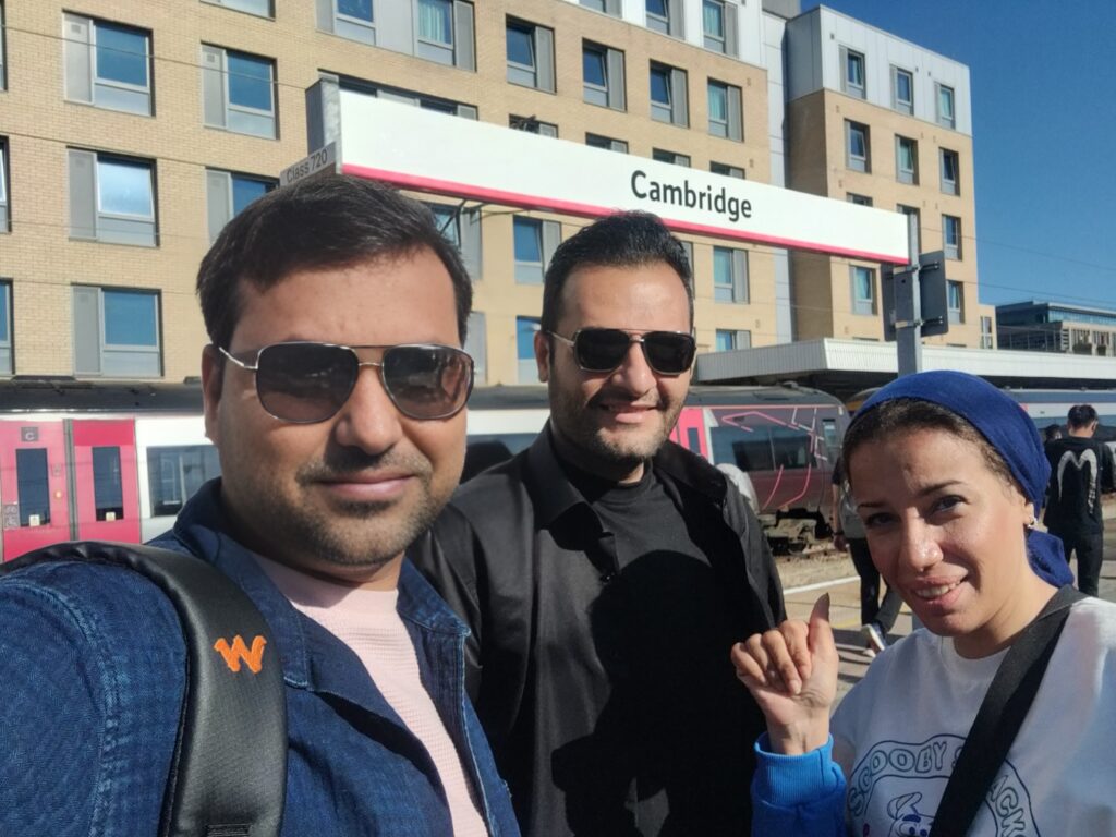 Selfie of Vinay, Abdulrhman, and Heba outside Cambridge station