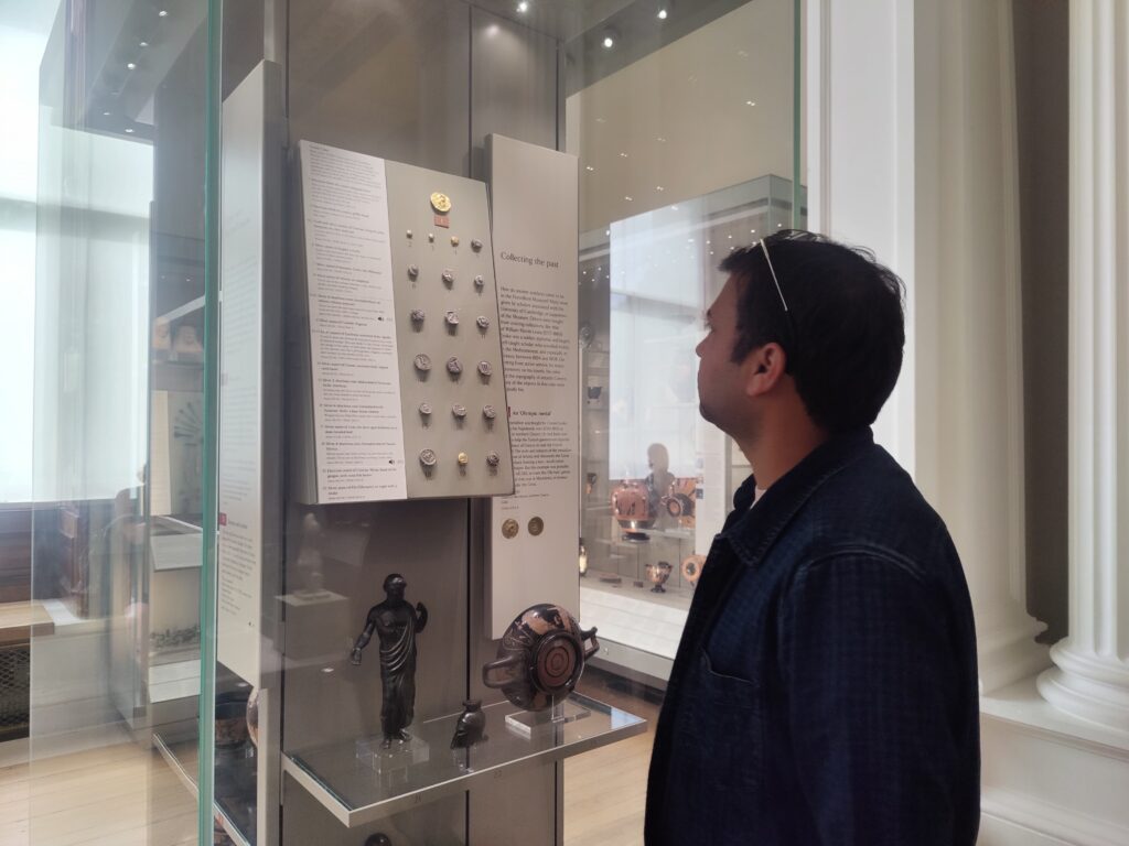 Photograph of Vinay looking at a showcase.