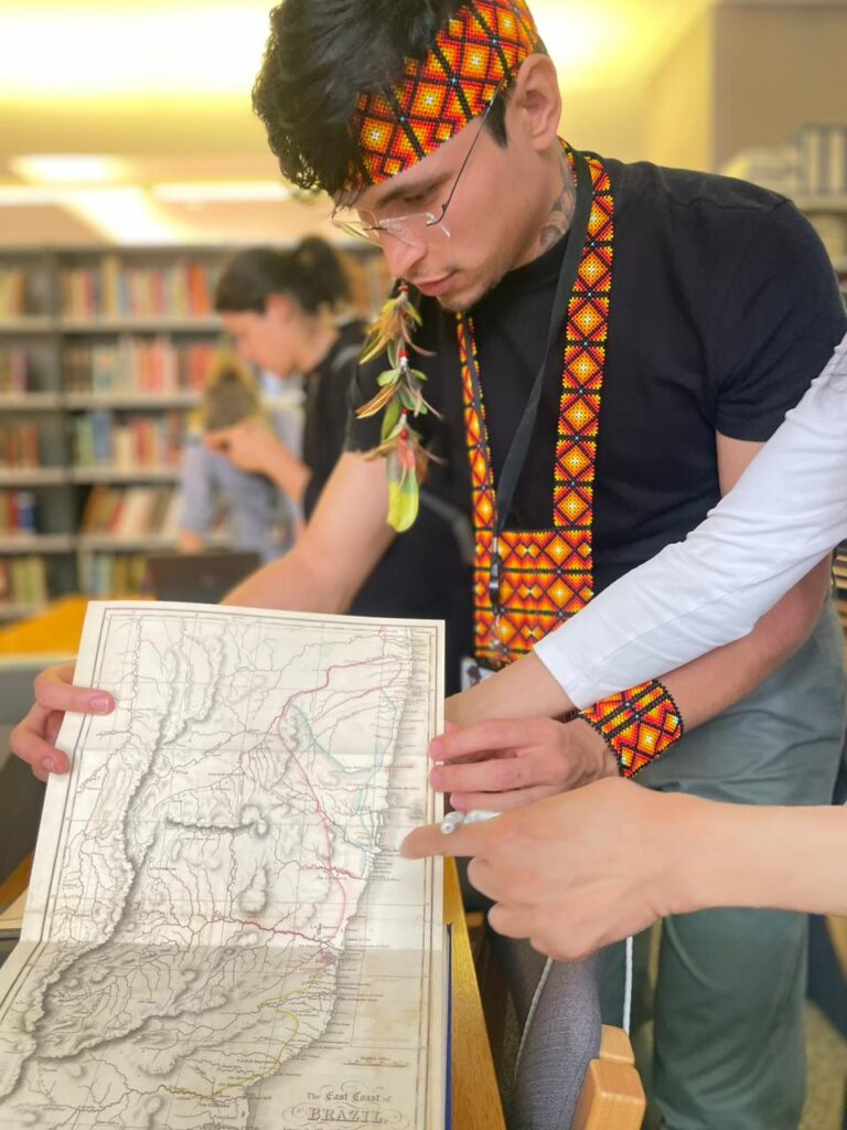 Photograph of Tarisson looking at a map
