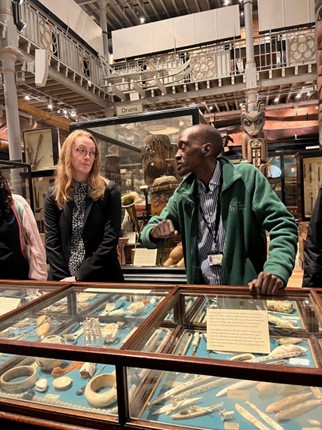 Photograph of people looking in a display case.