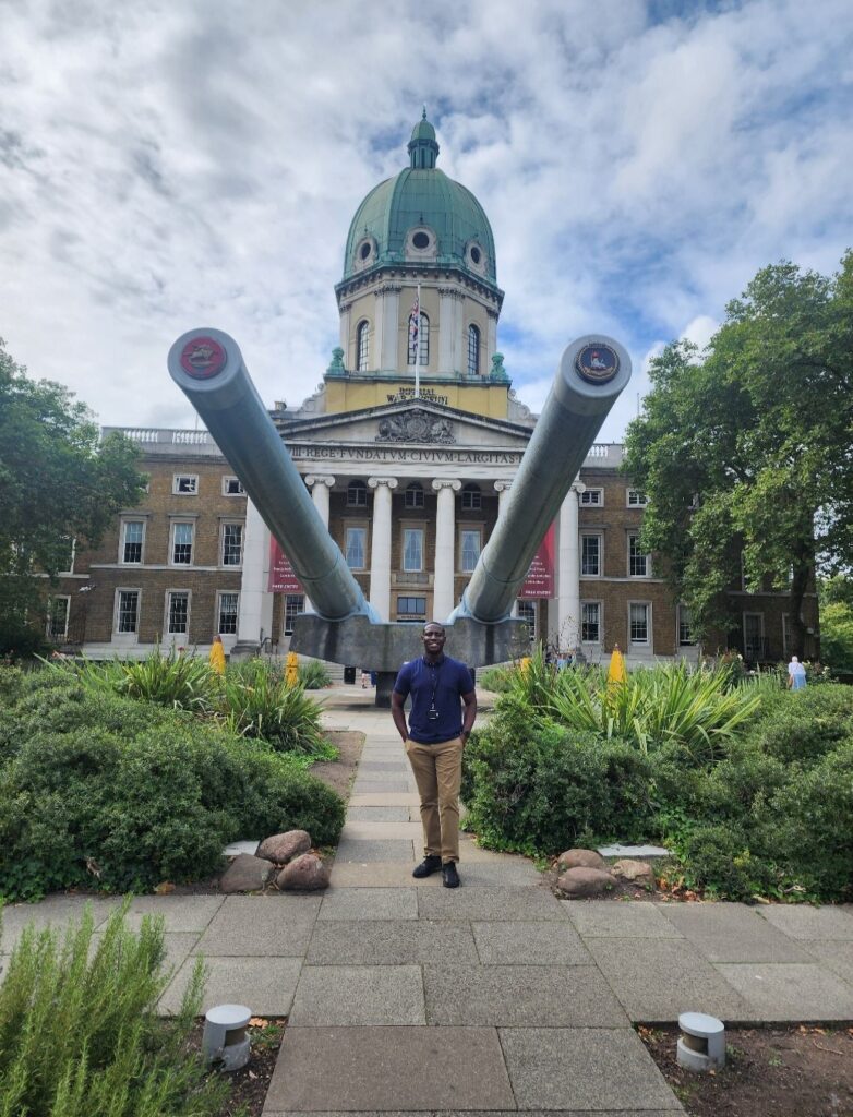 Photograph of Richard stood outside the Imperial War Museum.