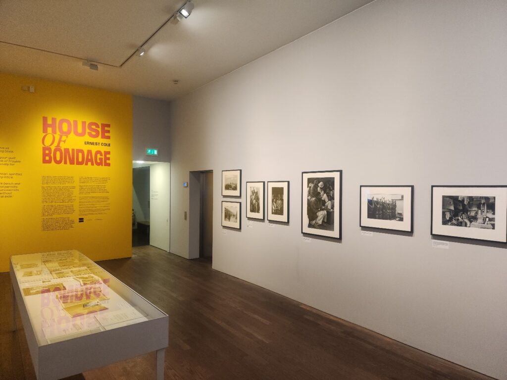Photograph of a gallery with framed photographs on the walls.