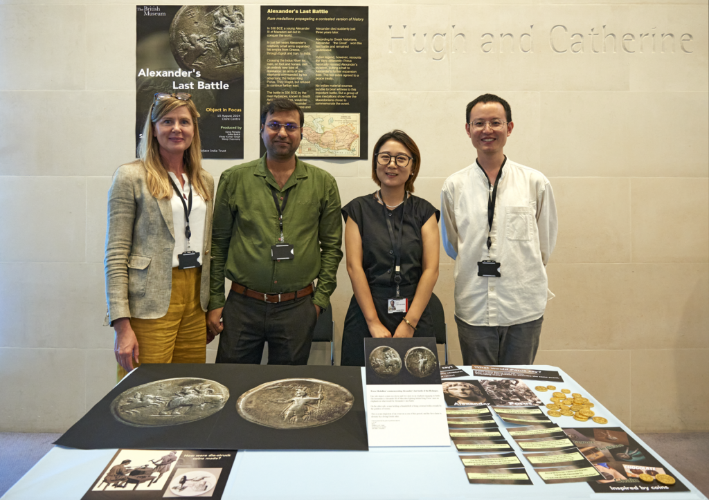 Asia and Money and Medals object in focus group standing with their project