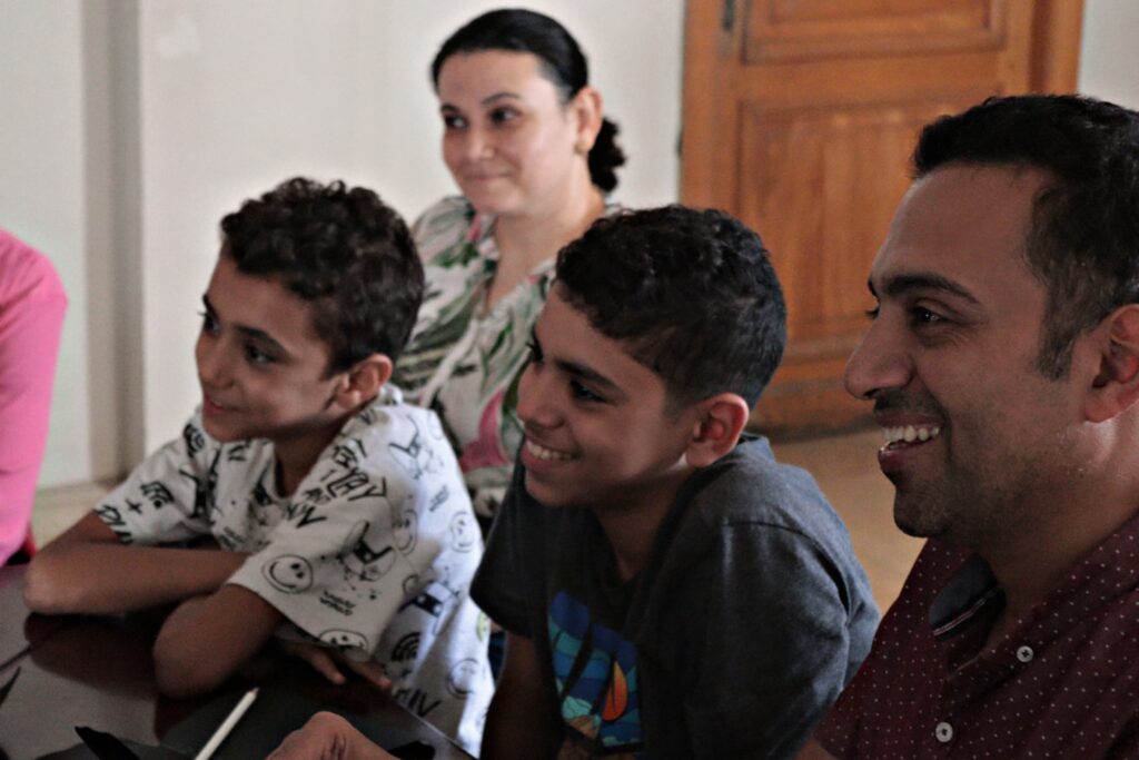 Photograph of three children smiling.