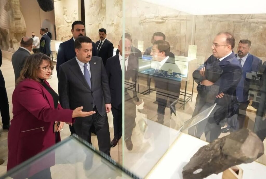 The Prime Minister of Iraq inspecting museum cases.