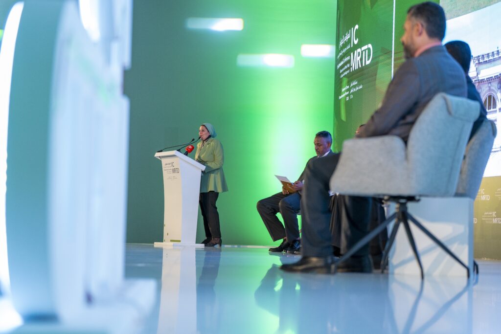 A woman speaking at a podium.