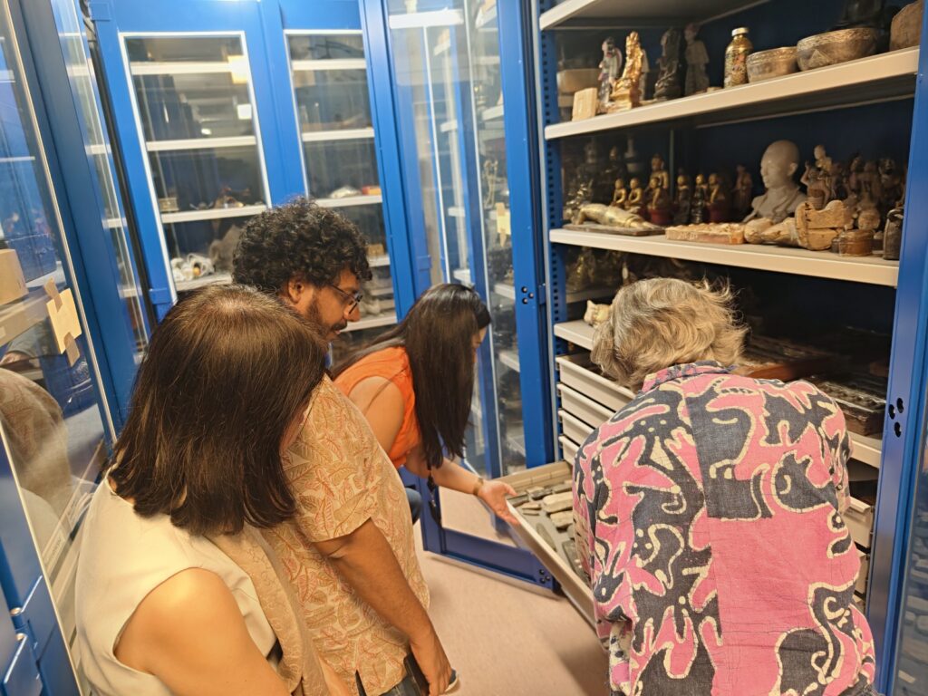 People looking at objects in a drawer