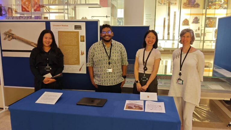 Four people stood in front of an object display
