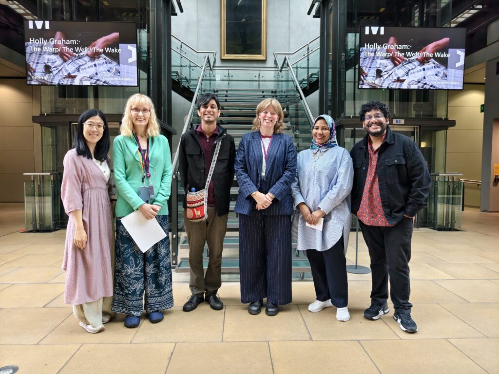 6 people posing for a photo in front of a staircase